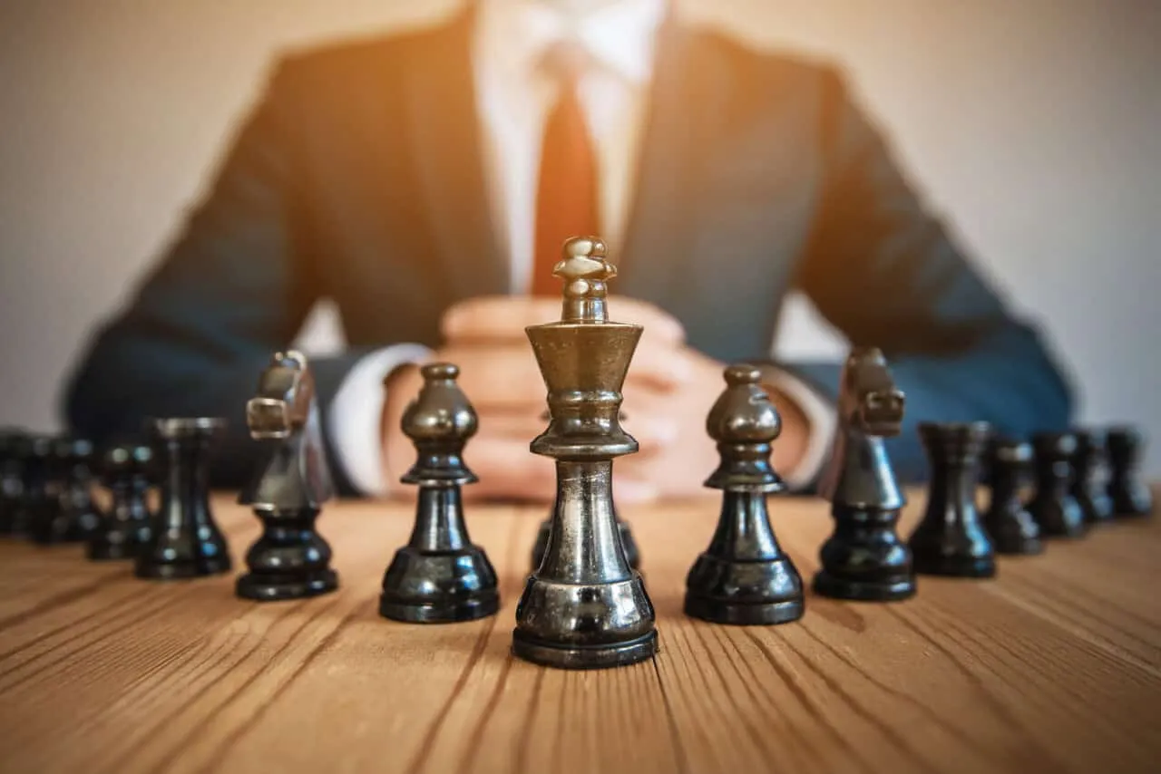 Businessman,Sitting,Behind,Chess,Figure,In,Competition,Success,Play.,Strategy,