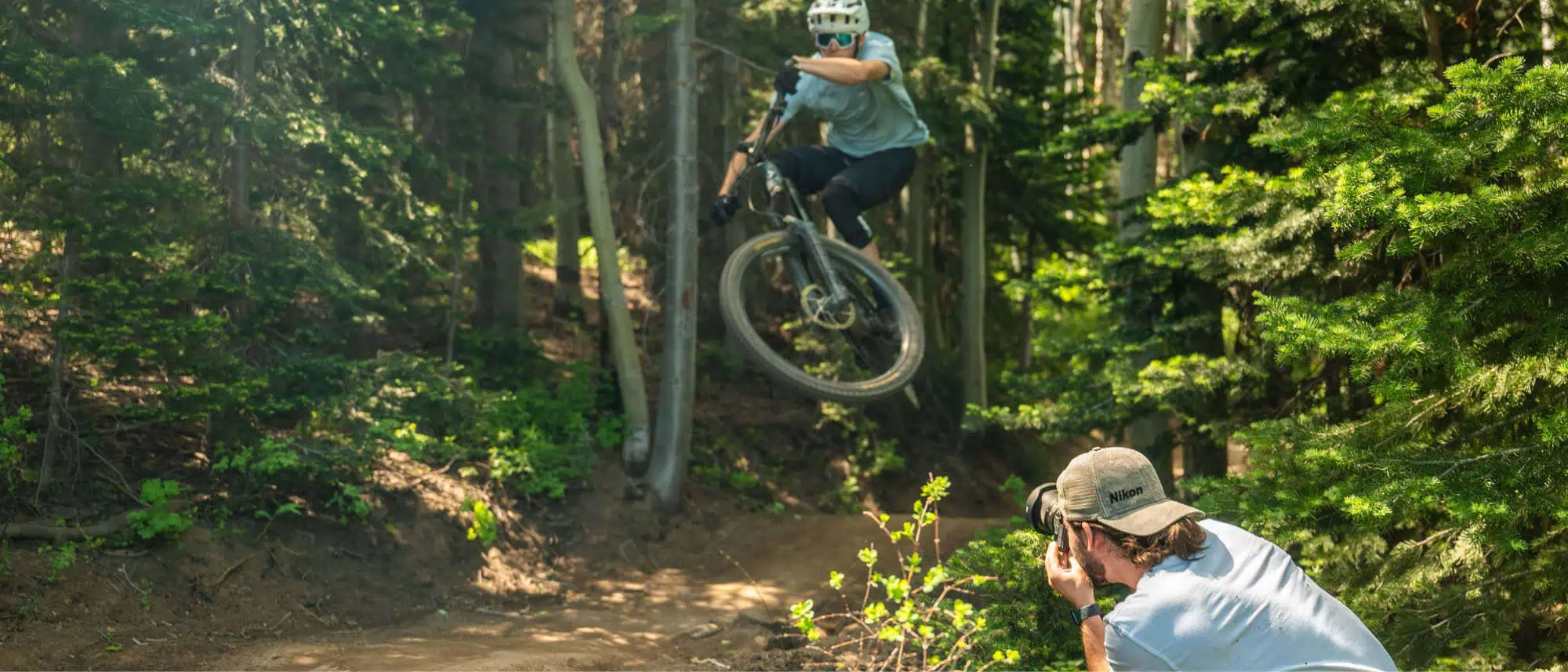 Image of photographer using Nikon camera to capture someone riding their bike outside
