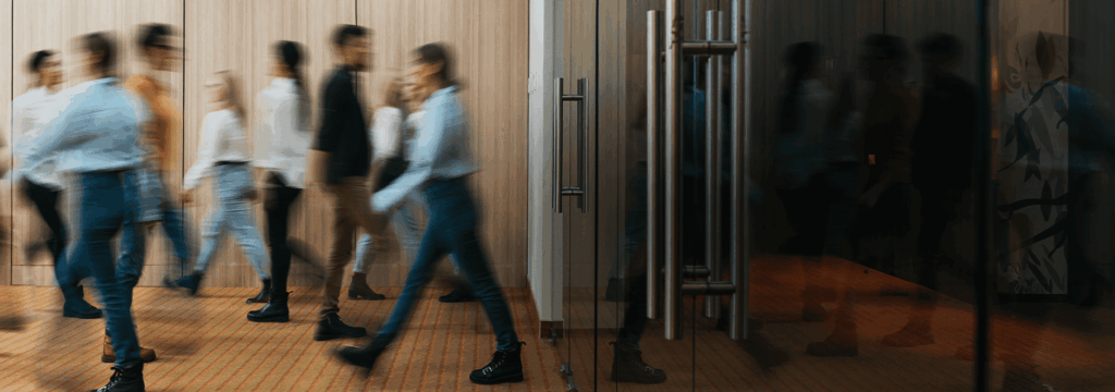 Business professionals walking in office corridor for employer branding.