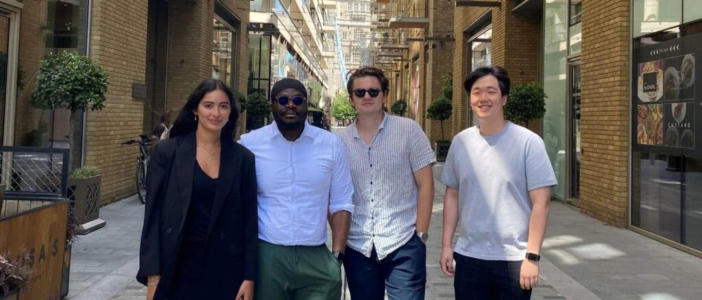 Group of four young professionals standing outdoors at MikeWorldWide.