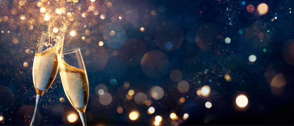 Stock image of a champagne glasses clinking in celebration