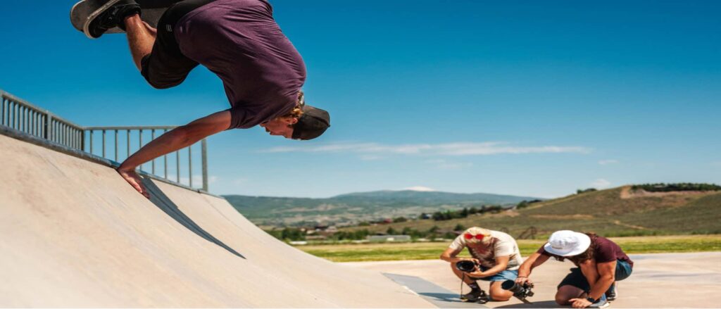 Image of two photographers using their Nikon camera to take pic of someone on a skateboard