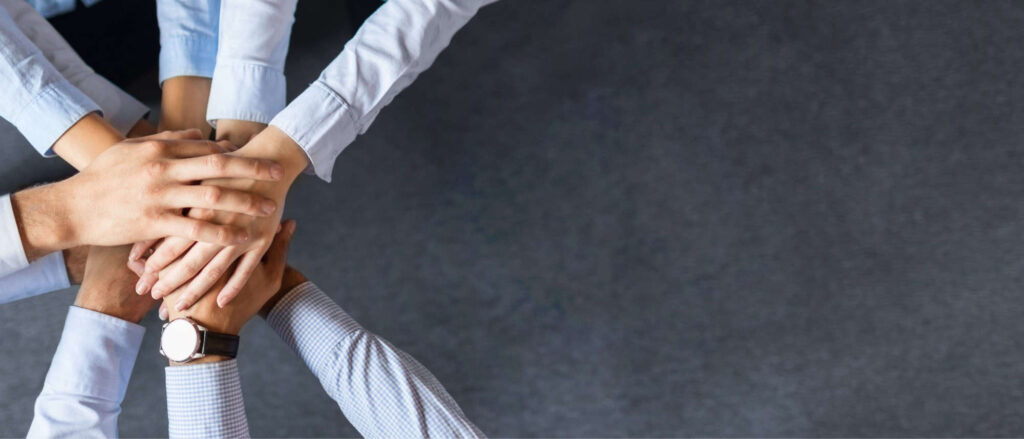 Stock image of hands piled on top of each other to showcase teamwork