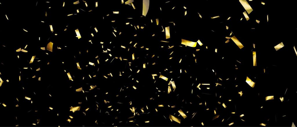 Stock image of gold confetti against black background